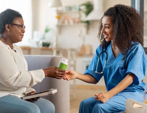 Thankful aged woman taking pills from caring medical attendant Caring medical attendant. Thankful aged woman taking pills from caring medical attendant in the nursing house